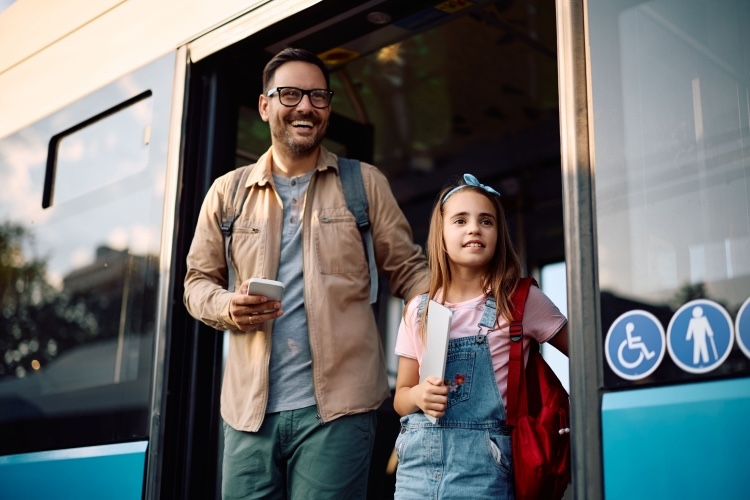 Happy man and happy child departing a private bus rental